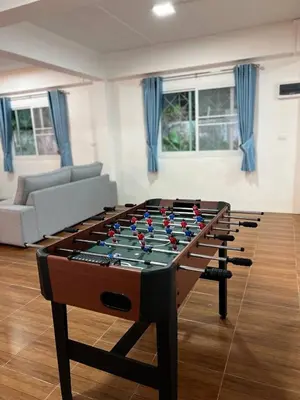 a large foosball table in a living room at Karon Beach Villa in Karon Beach