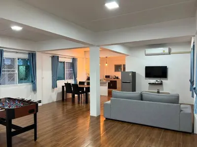 a living room with a couch and a table at Karon Beach Villa in Karon Beach