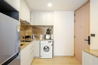 a kitchen with a washer and dryer in a room at The Ozone Condotel Phuket BangTao Beach Spacious 1-BR in Laguna Phuket