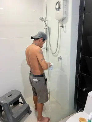 a man standing in a shower in a bathroom at OZONE Best Studio After Renovation 2025 in Kata Beach