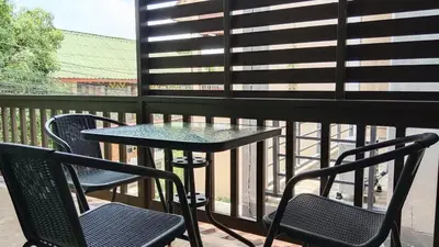 a table and two chairs on a balcony at Best Bliss, Bangtao Beach in Ban Thalat Choeng Thale