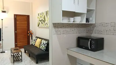 a living room with a tv and a couch at Best Bliss, Bangtao Beach in Ban Thalat Choeng Thale
