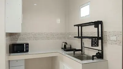 a kitchen with a sink and a microwave at Best Bliss, Bangtao Beach in Ban Thalat Choeng Thale