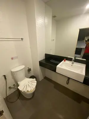 a bathroom with a sink and a toilet and a mirror at CHIC CONDO - Best mountain view near Karon beach in Karon Beach