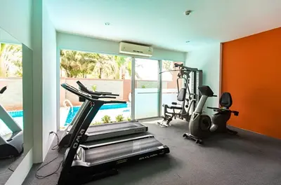 a fitness room with a treadmill and a gym at CHIC CONDO - Best mountain view near Karon beach in Karon Beach