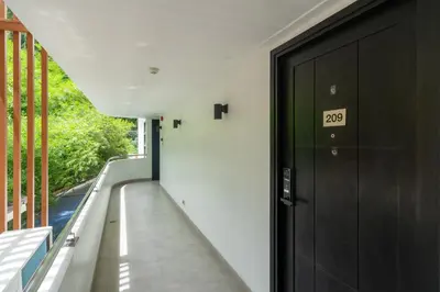 a hallway with a door with the number on it at Studio Apartment - Nakalay Palm in Kamala Beach