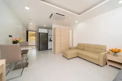 a living room with a couch and a table at Studio Apartment - Nakalay Palm in Kamala Beach