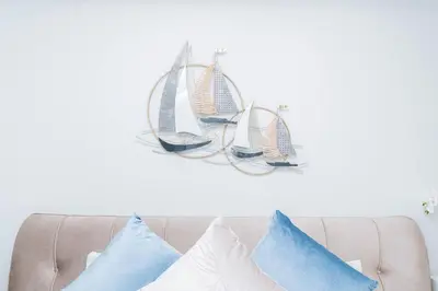 a group of pillows on a couch with sails on the wall at Laguna Skypark BangTao beach Phuket in Ban Thalat Choeng Thale