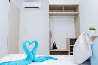 two blue swans sitting on top of a bed at Laguna Skypark BangTao beach Phuket in Ban Thalat Choeng Thale