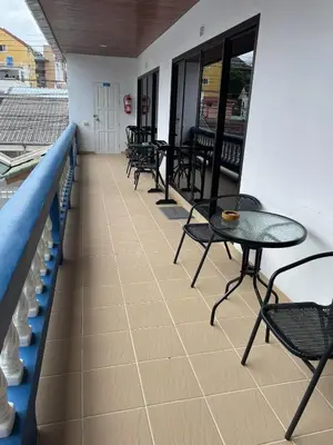 a row of tables and chairs on a balcony at Treff nad phop hotel in Patong Beach