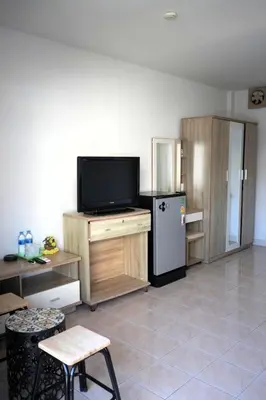 a living room with a tv and a refrigerator at Treff nad phop hotel in Patong Beach
