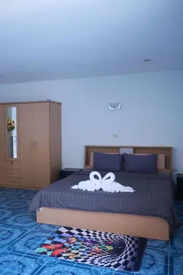 a bedroom with a bed with two bows on it at Treff nad phop hotel in Patong Beach