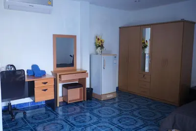 a room with a refrigerator and a desk and a mirror at Treff nad phop hotel in Patong Beach