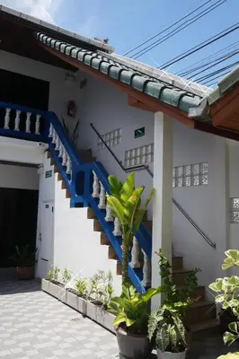 a house with a blue staircase on the side at Treff nad phop hotel in Patong Beach