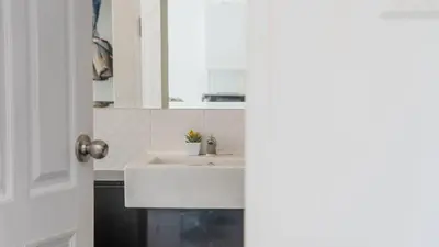 a bathroom with a white sink and a mirror at Mountain Loft 700m from Beach [Pool & Gym] in Karon Beach