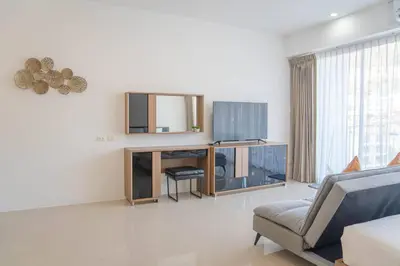 a living room with a mirror and a couch at Mountain Loft 700m from Beach [Pool & Gym] in Karon Beach
