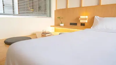 a bedroom with a white bed and a window at SeaView 1BR Apartment at Karon Beach in Karon Beach