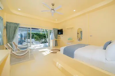 a bedroom with a bed and a ceiling fan at Loft with pool - 8min walk to Rawai Beach - 