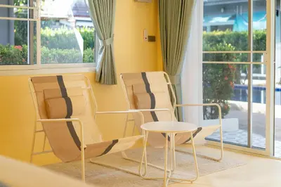 two chairs and a table in front of a window at Loft with pool - 8min walk to Rawai Beach - 