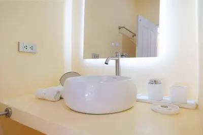 a white bathroom with a sink and a mirror at Loft with pool - 8min walk to Rawai Beach - 