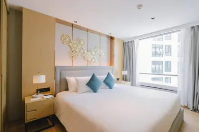 a bedroom with a large white bed and a window at Modern studio in Rawai 600m from the beach in Rawai Beach