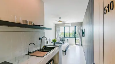a kitchen with a sink and a bed in a room at Quiet & Comfy studio near Rawai Beach - 
