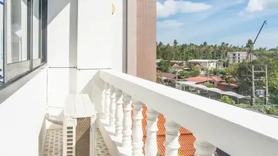 a white balcony with a view of a city at Quiet & Comfy studio near Rawai Beach - 