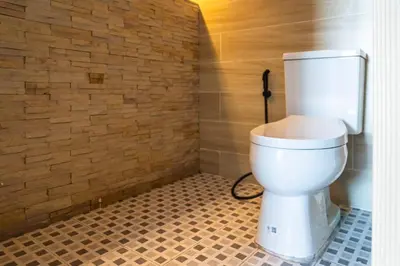 a bathroom with a white toilet in a room at Quiet & Comfy studio near Rawai Beach - 