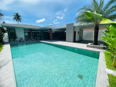 a swimming pool in front of a villa at Joy Villa - Luxury 4 bedroom villa in Ban Saiyuan (1)