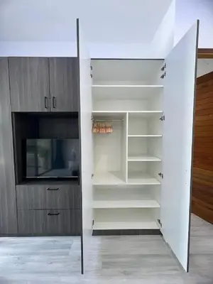 a closet with white shelves and a tv at Joy Villa - Luxury 4 bedroom villa in Ban Saiyuan (1)