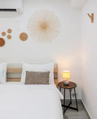 a bedroom with a bed and a table with a lamp at La Ferme Villa - Modern 3 Bedrooms with Private Pool in Rawai Beach