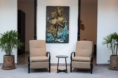 a lobby with two chairs and a painting on the wall at La Ferme Villa - Modern 3 Bedrooms with Private Pool in Rawai Beach