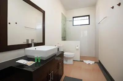 a bathroom with a sink and a toilet at La Ferme Villa - Modern 3 Bedrooms with Private Pool in Rawai Beach