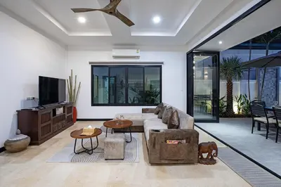 a living room with a couch and a table at La Ferme Villa - Modern 3 Bedrooms with Private Pool in Rawai Beach
