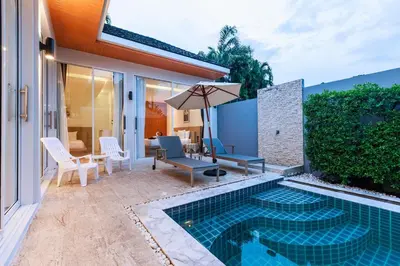 a backyard with a swimming pool and a house at Lilly Villa - 2 Bedrooms Villa with Private Pool in Rawai Beach