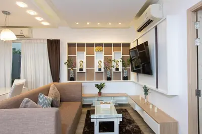 a living room with a couch and a tv at Lilly Villa - 2 Bedrooms Villa with Private Pool in Rawai Beach