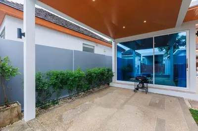a screened in porch of a home with a large window at Lilly Villa - 2 Bedrooms Villa with Private Pool in Rawai Beach