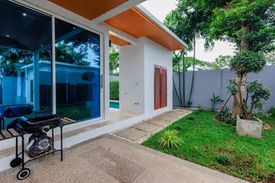 a barbecue outside of a house with a yard at Lilly Villa - 2 Bedrooms Villa with Private Pool in Rawai Beach