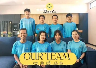 a group of men and women in blue shirts holding a sign at Lilly Villa - 2 Bedrooms Villa with Private Pool in Rawai Beach
