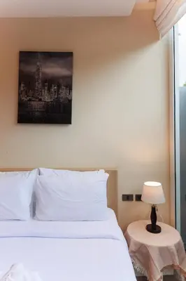 a bedroom with a white bed and a picture on the wall at Lilly Villa - 2 Bedrooms Villa with Private Pool in Rawai Beach