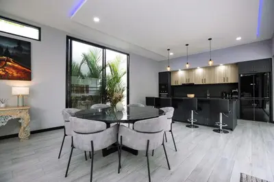 a dining room and kitchen with a table and chairs at Lynn Villa - 3 Bedrooms with Private Pool in Rawai Beach
