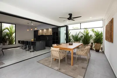 an open kitchen and dining room with a table and chairs at Lynn Villa - 3 Bedrooms with Private Pool in Rawai Beach