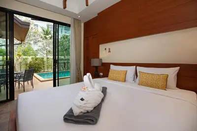a bedroom with a bed with a towel on it at Orchid Villa - 3 Bedrooms Pool Villa - Rawai beach in Rawai Beach