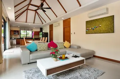 a living room with a couch and a table at Orchid Villa - 3 Bedrooms Pool Villa - Rawai beach in Rawai Beach