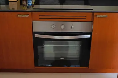 a stainless steel oven in a kitchen with wooden cabinets at Orchid Villa - 3 Bedrooms Pool Villa - Rawai beach in Rawai Beach