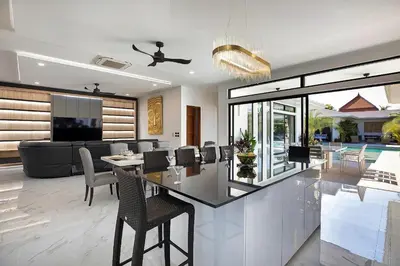 a dining room and living room with a table and chairs at Palm Villa - Spacious 4 Bedrooms with Private Pool in Rawai Beach