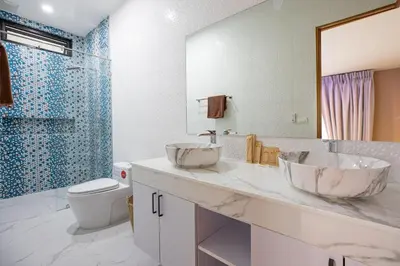 a bathroom with two sinks and a toilet at Pattana Moon - Luxury Calm 4 Bedrooms Pool Villa in Ban Saiyuan (1)