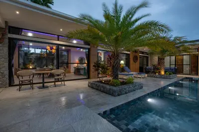 a villa with a swimming pool and a house at Pattana Moon - Luxury Calm 4 Bedrooms Pool Villa in Ban Saiyuan (1)
