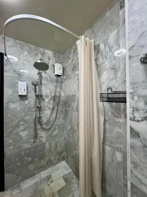 a bathroom with a shower with a shower curtain at Cozy Condotel Maikhao in Mai Khao Beach