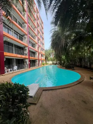 an empty swimming pool in front of a building at Cozy Condotel Maikhao in Mai Khao Beach